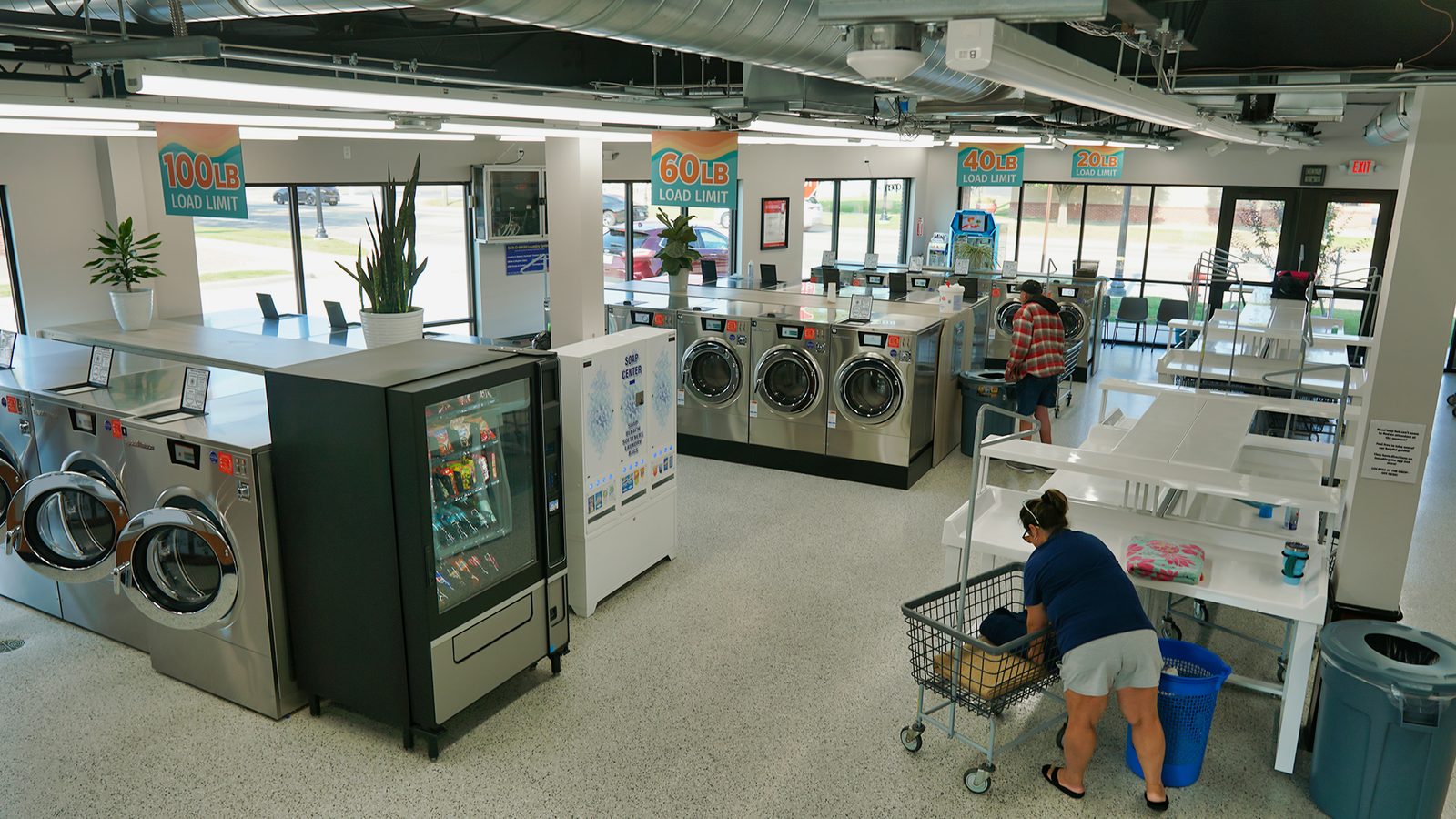 Bright, modern interior at mClean Laundry with rows of Speed Queen machines